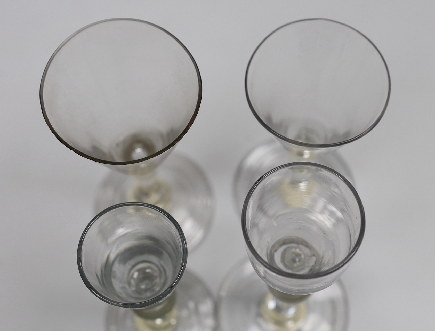 Four various George II wine/cordial glasses, three with folded feet, tallest 14cm